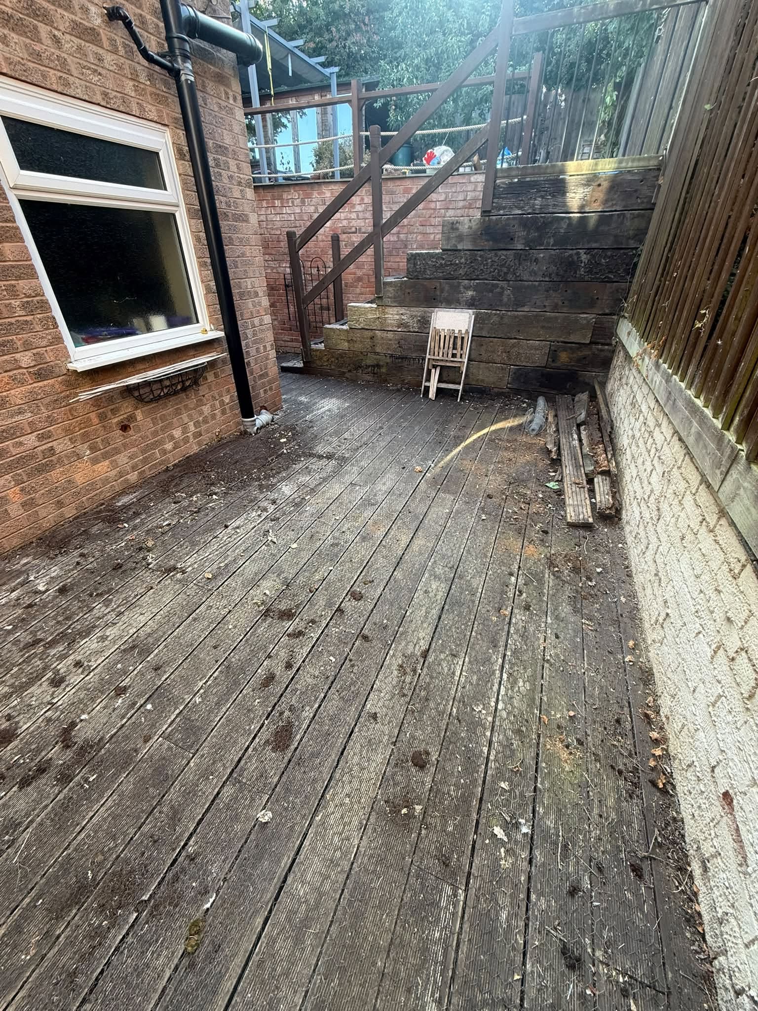 Side return before the work: old, worn timber decking