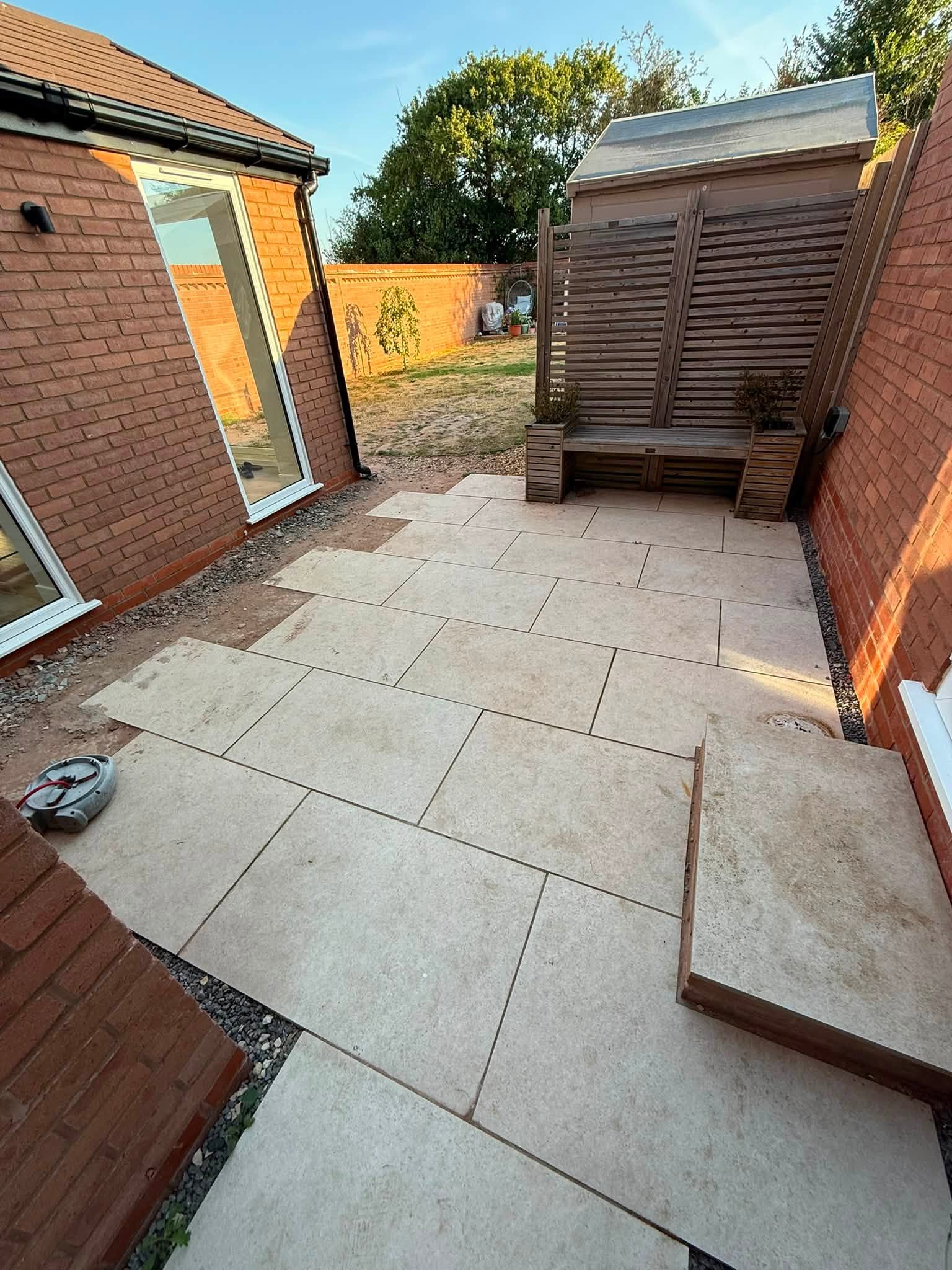 Sandstone patio with a built-in timber bench
